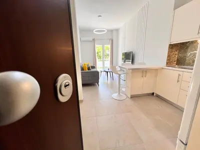 a door to a kitchen and a living room at Downtown Bliss - Piraeus Street by ΜΡS in Athens