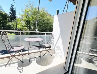 a table and two chairs on a balcony at Downtown Bliss - Piraeus Street by ΜΡS in Athens