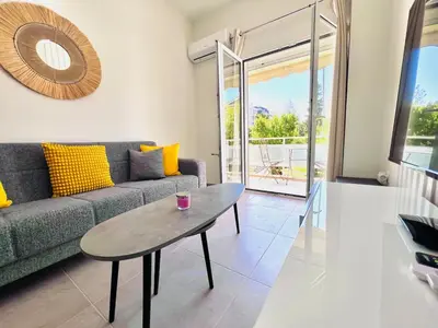 a living room with a couch and a table at Downtown Bliss - Piraeus Street by ΜΡS in Athens