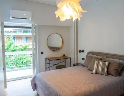 a bedroom with a bed and a chandelier at The halcyon house in Athens