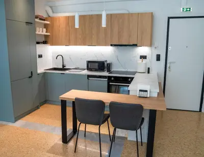 a kitchen with a wooden table and two chairs at The halcyon house in Athens