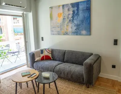 a living room with a couch and a table at The halcyon house in Athens