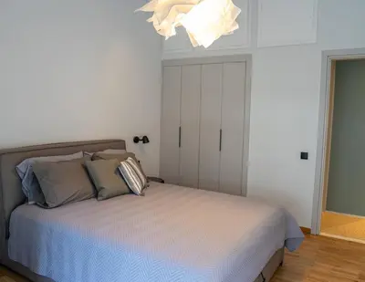 a bedroom with a bed and a chandelier at The halcyon house in Athens