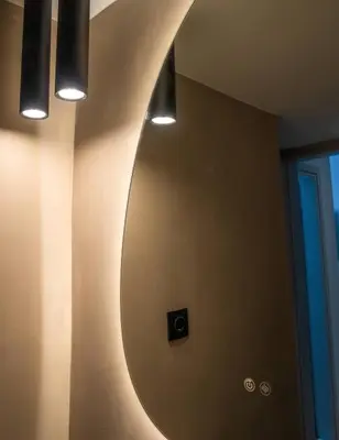 a bathroom with a round mirror on the wall at The halcyon house in Athens