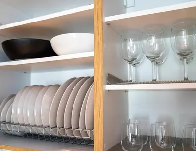 a shelf with wine glasses and plates on it at The halcyon house in Athens