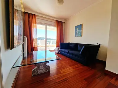 a living room with a glass table and a couch at Ethea in Anavissos