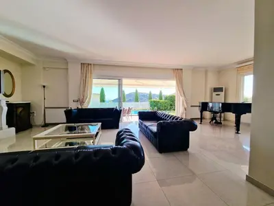 a living room with couches and a piano at Ethea in Anavissos