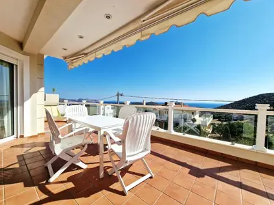 a patio with a table and chairs on a balcony at Ethea in Anavissos