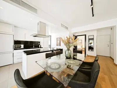 a kitchen and dining room with a glass table and chairs at Voula Private Pool, Beach, Home cinema Apartment in Athens