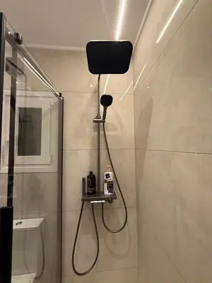 a bathroom with a shower with a stand up shower at Solvy Beachfront Suite-Direct to City Center & Piraeus Port & Airport in Athens
