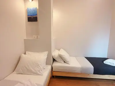 a small bedroom with a bed and a couch at Solvy Beachfront Suite-Direct to City Center & Piraeus Port & Airport in Athens