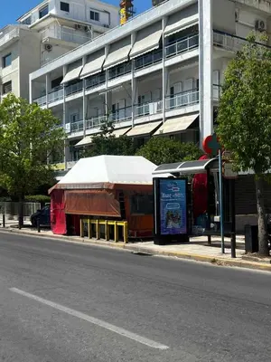 a building with a tent on the side of a street at Solvy Beachfront Suite-Direct to City Center & Piraeus Port & Airport in Athens