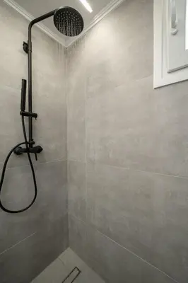 a shower with a shower head in a bathroom at Santa Marina - Comfortable & Cozy House in Egaleo-Athens in Athens
