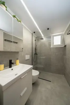 a bathroom with a white sink and a toilet at Santa Marina - Comfortable & Cozy House in Egaleo-Athens in Athens