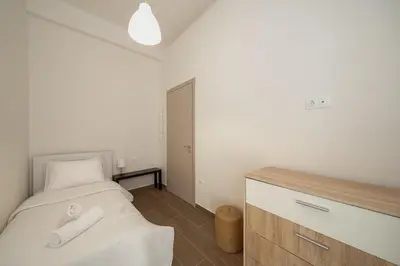 a bedroom with a bed with two towels on it at Santa Marina - Comfortable & Cozy House in Egaleo-Athens in Athens