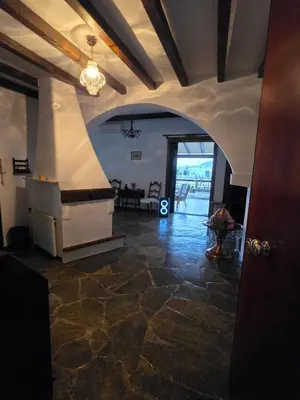 a living room with a stone floor and an archway at The-terrace-of-glyfada in Athens