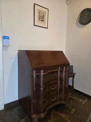 a wooden desk in a room with a clock on the wall at The-terrace-of-glyfada in Athens