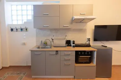 a small kitchen with a sink and a microwave at Alexandra's apartment in Porto Rafti