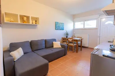 a living room with a couch and a table at Alexandra's apartment in Porto Rafti