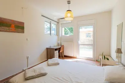 a bedroom with a bed and a desk in it at Alexandra's apartment in Porto Rafti