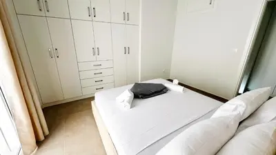 a room with a bed and white cabinets at Fifth Sense in Athens by ΜPS in Athens