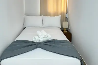 a bedroom with a bed with two towels on it at Fifth Sense in Athens by ΜPS in Athens