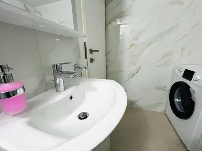 a white bathroom with a sink and a washing machine at Fifth Sense in Athens by ΜPS in Athens
