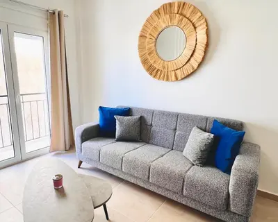 a living room with a couch and a mirror at Fifth Sense in Athens by ΜPS in Athens