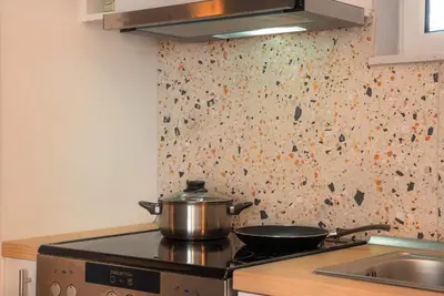 a pot on a stove top in a kitchen at Joo Nest - Your home near Piraeus Port in Piraeus