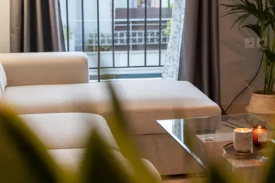 a living room with a couch and a coffee table at Joo Nest - Your home near Piraeus Port in Piraeus