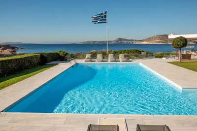 a swimming pool with a view of the ocean at Paradise Beachfront Villa Athenian Riviera in Aghia Marina