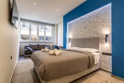 a bedroom with a large bed with two stuffed animals on it at Luxurius Studio Near Plaka & Acropolis 4 in Athens