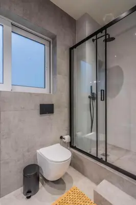 a bathroom with a toilet and a glass shower at Luxurius Studio Near Plaka & Acropolis 4 in Athens
