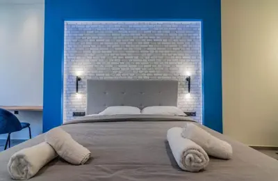 a bedroom with a large bed with towels on it at Luxurius Studio Near Plaka & Acropolis 4 in Athens