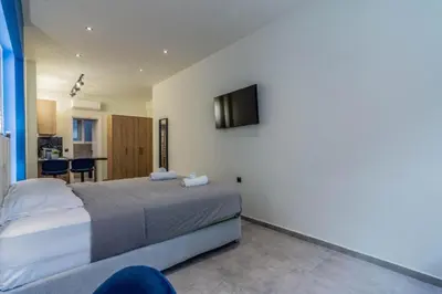 a bedroom with a bed and a tv on the wall at Luxurius Studio Near Plaka & Acropolis 4 in Athens