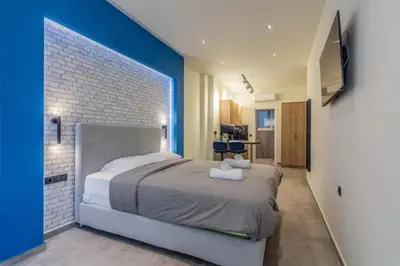 a bedroom with a large bed and a blue wall at Luxurius Studio Near Plaka & Acropolis 4 in Athens