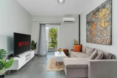 a living room with a couch and a tv at Aera Nest - 2BR, Alimos in Athens