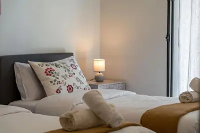 a bedroom with a stuffed animal laying on a bed at Aera Nest - 2BR, Alimos in Athens