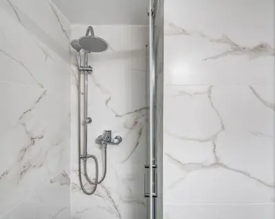 a shower with a glass door in a bathroom at Aera Nest - 2BR, Alimos in Athens