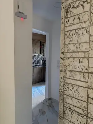 a room with a stone wall and a kitchen at Aphrodite Apartment in Athens