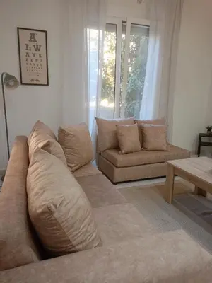 a living room with a couch and a table at Keep it simple Athens in Athens