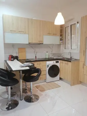 a kitchen with a table and a washing machine at Keep it simple Athens in Athens