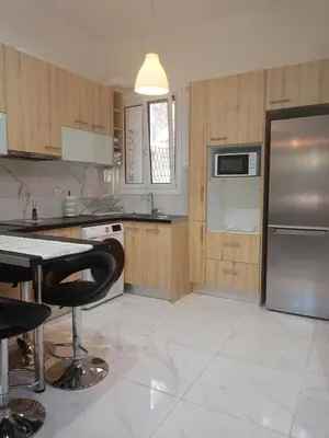 a kitchen with a stainless steel refrigerator and a table at Keep it simple Athens in Athens