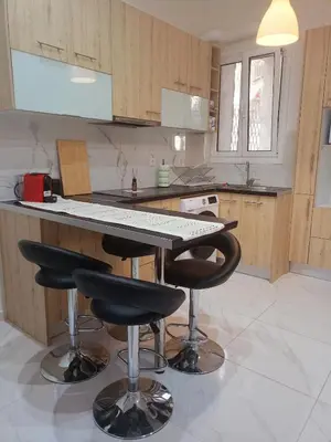 a kitchen with a table and two bar stools at Keep it simple Athens in Athens