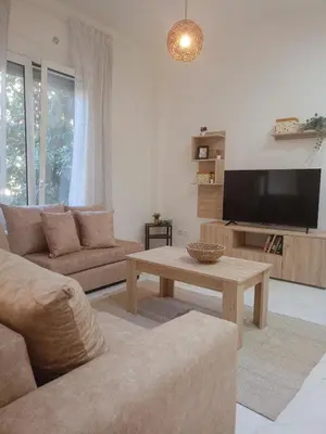 a living room with a couch and a coffee table at Keep it simple Athens in Athens