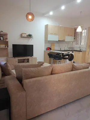 a living room with a couch and a kitchen at Keep it simple Athens in Athens