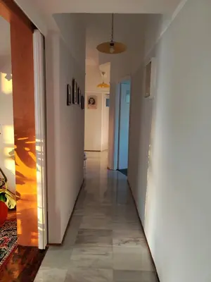 a hallway with white walls and tile floors at Mediterranean Penthouse in the center of Athens in Athens