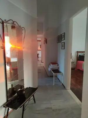 a living room with a mirror and a bench at Mediterranean Penthouse in the center of Athens in Athens
