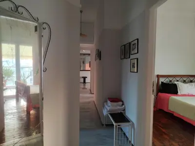 a bedroom with a bed and a door to a living room at Mediterranean Penthouse in the center of Athens in Athens