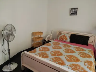 a bedroom with a bed with a fan next to it at Mediterranean Penthouse in the center of Athens in Athens
